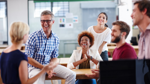 Engaging and fun - what could be a health and safety training a group of employees laughing at a workplace workshop