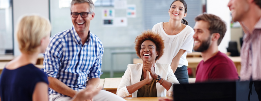 Engaging and fun health and safety training a group of employees laughing at a workplace workshop