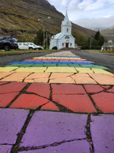 Iceland rainbow road leading to a church